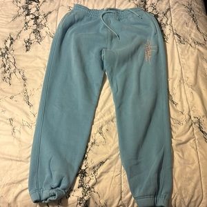 Baby blue sweatpants w/ a coral orange “Hollister California” written in cursive